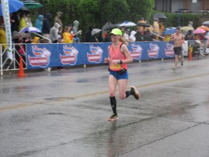 Me running toward the finish line of the Kentucky Derby Festival Mini Marathon (in the rain, but still smiling) - Louisville, KY
